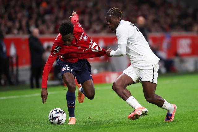 Lille's Portuguese forward #27 Felix Correia (L) fights for the ball with Angers' Gabonese defender #03 Jacques Ekomie during the French L1 football match between LOSC Lille and Angers SCO at Stade Pierre-Mauroy in Villeneuve-d'Ascq, near Lille on November 2, 2025. (Photo by Anne-Christine POUJOULAT / AFP)