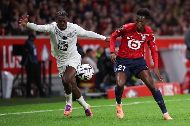 Angers' Gabonese defender #03 Jacques Ekomie (L) fights for the ball with Lille's Portuguese forward #27 Felix Correia during the French L1 football match between LOSC Lille and Angers SCO at Stade Pierre-Mauroy in Villeneuve-d'Ascq, near Lille on November 2, 2025. (Photo by Anne-Christine POUJOULAT / AFP)