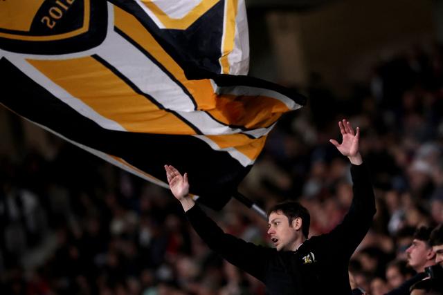 A Lille's supporter cheers during the French L1 football match between LOSC Lille and Angers SCO at Stade Pierre-Mauroy in Villeneuve-d'Ascq, near Lille on November 2, 2025. (Photo by Anne-Christine POUJOULAT / AFP)
