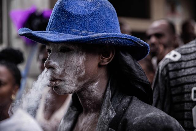 A man attends Fet Gede, the traditional Haitian Day of the Dead celebration at the Port-au-Prince cemetery, in Haiti, on November 2, 2025. Fet Gede is the annual celebration when practitioners of vodou parade and believe to be possessed by the spirits of the dead. (Photo by Clarens SIFFROY / AFP)