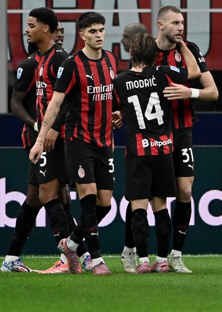 AC Milan's Serbian defender #31 Strahinja Pavlovic (R) celebrates scoring his team's first goal during the Italian Serie A football match between AC Milan and AS Roma at San Siro stadium in Milan, on November 2, 2025. (Photo by Isabella BONOTTO / AFP)