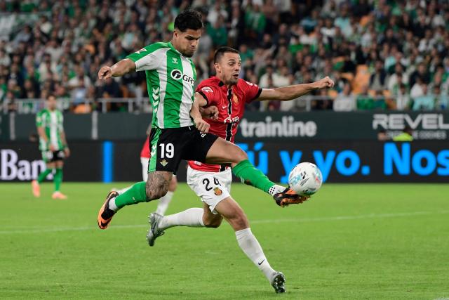 TOPSHOT - Real Betis' Colombian forward #19 Cucho Hernandez and Real Mallorca's Slovak defender #24 Martin Valjent fight for the ball during the Spanish league football match between Real Betis and RCD Mallorca at Benito Villamarin Stadium in Seville on November 2, 2025. (Photo by CRISTINA QUICLER / AFP)
