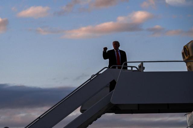 US President Donald Trump pumps his fist while boarding Air Force One at Palm Beach International Airport in West Palm Beach, Florida, on November 2, 2025. Trump is returning to the White House from his Mar-a-Lago, Florida, residence where he spent the weekend. (Photo by ROBERTO SCHMIDT / AFP)