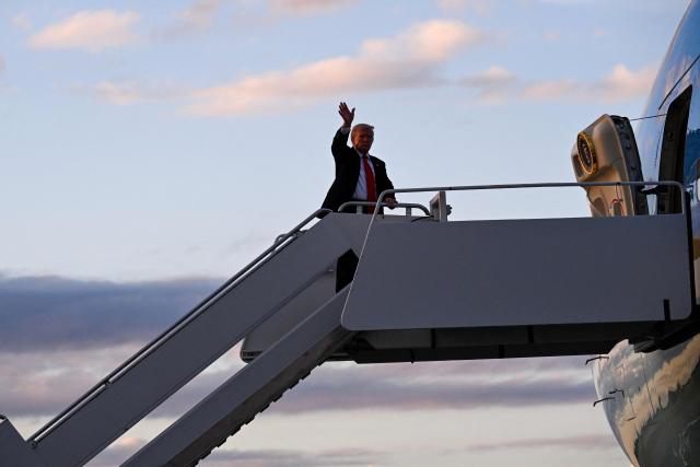 US President Donald Trump waves while boarding Air Force One at Palm Beach International Airport in West Palm Beach, Florida, on November 2, 2025. Trump is returning to the White House from his Mar-a-Lago, Florida, residence where he spent the weekend. (Photo by ROBERTO SCHMIDT / AFP)