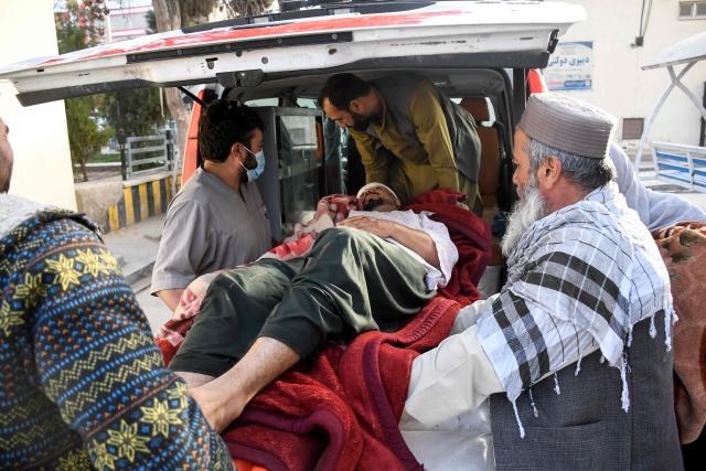 Afghan men assist an injured man into an ambulance in the aftermath of an earthquake, that struck overnight at Mazar-i-Sharif on November 3, 2025. A 6.3-magnitude strong earthquake killed at least nine people in northern Afghanistan, authorities said on November 3, just months after another deadly tremor left the country reeling. (Photo by Atif Aryan / AFP)