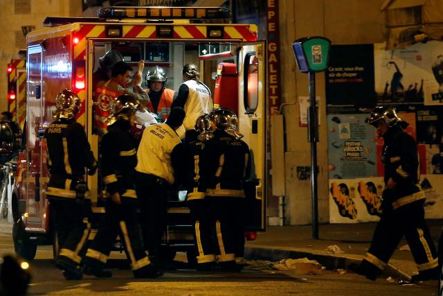 (FILES) Rescue workers evacuate victims near La Belle Equipe, rue de Charonne, at the site of an attack, in Paris on November 14, 2015 after a series of gun attacks occurred across Paris as well as explosions outside the national stadium where France was hosting Germany. November 15, 2025 will mark the tenth anniversary of the November 13 attacks, a series of gun attacks that occurred across Paris and outside the national stadium (Stade de France) in Saint-Denis, North of Paris, on November 13, 2015. (Photo by PIERRE CONSTANT / AFP)