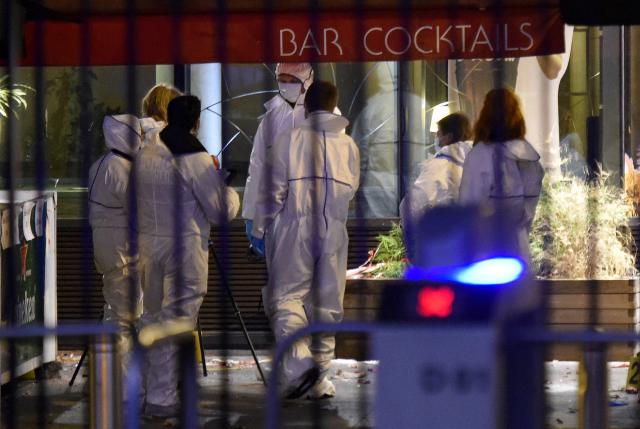 (FILES) Forensic experts inspect the site of an attack outside the Stade de France in Saint-Denis, north of Paris, early on November 14, 2015, after a series of gun attacks occurred across Paris as well as explosions outside the national stadium where France was hosting Germany. November 15, 2025 will mark the tenth anniversary of the November 13 attacks, a series of gun attacks that occurred across Paris and outside the national stadium (Stade de France) in Saint-Denis, North of Paris, on November 13, 2015. (Photo by Franck FIFE / AFP)