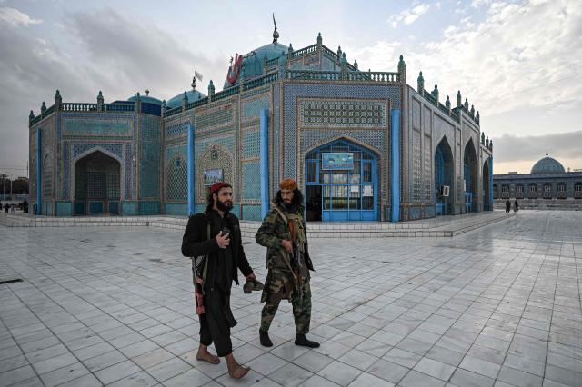 (FILES) Taliban fighters walk through the compound of the Hazrat-e-Ali shrine or the Blue Mosque in Mazar-i-Sharif on December 23, 2021. The Blue Mosque of Mazar-i-Sharif, a 15th-century landmark famed for its vibrant tiles, was damaged by a magnitude 6.3 earthquake that struck northern Afghanistan overnight, an AFP journalist saw on November 3, 2025. (Photo by Mohd RASFAN / AFP)