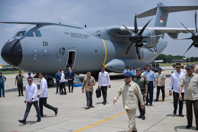 Indonesian President Prabowo Subianto (front blue cap) takes part in a handover ceremony of one of two Airbus A-400M military transport aircraft to the Indonesian Air Force at Halim air base in Jakarta on November 3, 2025. (Photo by BAY ISMOYO / AFP)