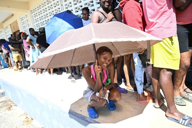 Residents wait in line to receive food supplies in the Whitehouse community of Westmoreland, Jamaica, one of the areas hardest hit by Hurricane Melissa, on November 2, 2025. Planes and helicopters carrying humanitarian aid headed to Jamaica on October 31, three days after Melissa slammed into the island nation and killed at least 19 people.
Information Minister Dana Morris Dixon told a briefing that authorities had "quite credible" reports of possibly five additional deaths but had not yet been able to confirm. (Photo by Ricardo Makyn / AFP)