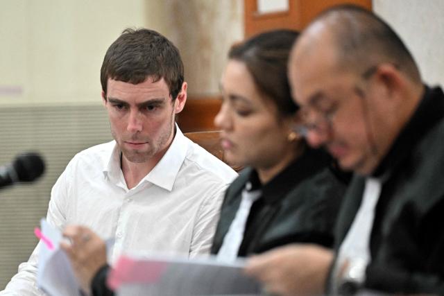 Australian suspect Darcy Francesco Jenson (L) attends his trial at a courtroom in Denpasar on Indonesia's resort island of Bali on November 3, 2025. The trial of three Australians accused of plotting the murder of a compatriot at a villa in Bali began on October 30, 2025, with all facing the death penalty. (Photo by SONNY TUMBELAKA / AFP)