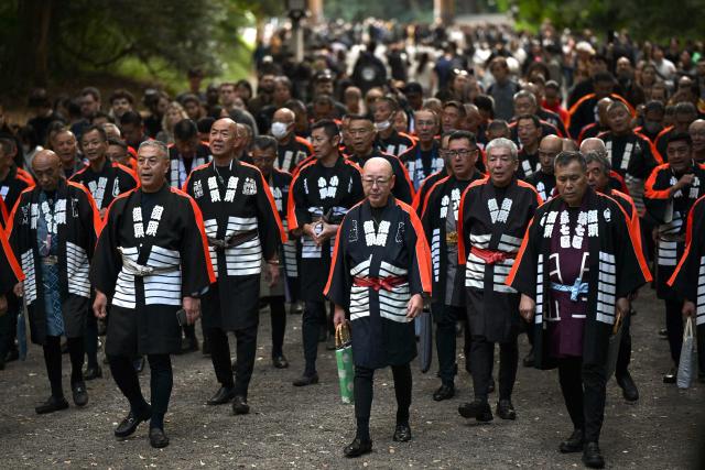Japanese men take part in a traditional parade during the Meiji Shrine Autumn Festival in Tokyo on November 3, 2025. (Photo by Greg Baker / AFP)