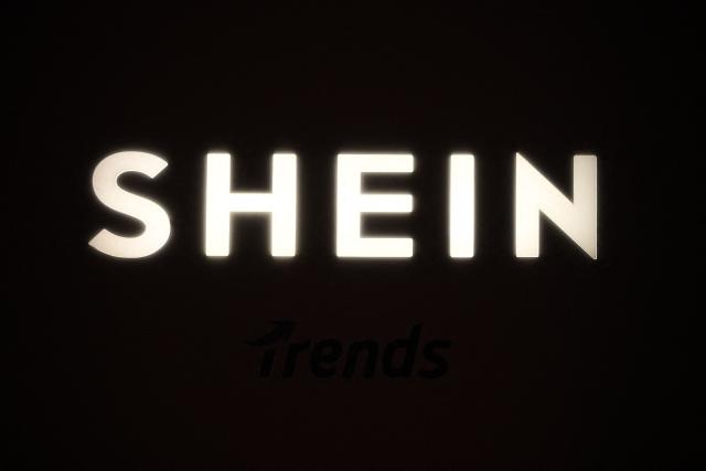 (FILES) A picture shows the logo Shein during the Urban Ritual fashion show Fall-Winter 2025/26 organized by Chinese fashion giant Shein in Milan, on October 16, 2025. The Minister of Economy, Roland Lescure, said on November 3, 2025 that he would seek to ban Shein from France if it sold sex dolls with child pornography again, which the Asian e-commerce giant has assured it has removed from its sales platform. (Photo by Piero CRUCIATTI / AFP)