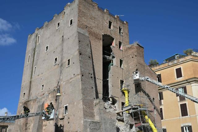Firefighters work on the site after a part of medieval tower "Torre dei Conti" collapses near the Forum in the historic center of Rome on November 3, 2025. (Photo by Tiziana FABI / AFP)
