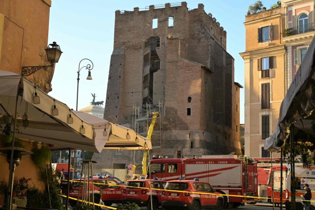 Firefighters work on the site after a part of medieval tower "Torre dei Conti" collapses near the Roman Forum in the historic center of Rome on November 3, 2025. Three workers inside were evacuated, with one taken to hospital in critical condition, a spokesman for firefighters told AFP. But one worker remained inside, according to an official from the mayor's office. (Photo by Tiziana FABI / AFP)