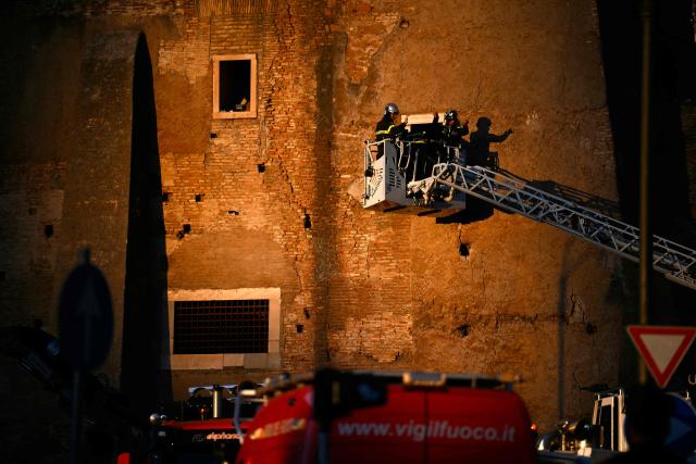Firefighters work on the site after a part of medieval tower "Torre dei Conti" collapses near the Roman Forum in the historic center of Rome on November 3, 2025. Three workers inside were evacuated, with one taken to hospital in critical condition, a spokesman for firefighters told AFP. But one worker remained inside, according to an official from the mayor's office. (Photo by Filippo MONTEFORTE / AFP)