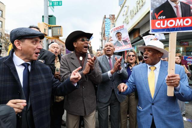 Former New York City Council member Ruben Diaz Sr. (in cowboy hat 2L) cheers for former New York Governor Andrew Cuomo (out of frame), independent candidate for New York City mayor, as Cuomo makes a campaign stop in the Washington Heights neighborhood in the Manhattan borough of New York City on November 3, 2025. New Yorkers will pick a new mayor on November 4 after an unpredictable race that has drawn attention from far beyond the largest city in the United States, with President Donald Trump branding frontrunner Zohran Mamdani "a communist."  Breakout Democratic Party candidate Mamdani, a naturalized Muslim American who represents Queens in the state legislature, leads former governor and sex assault-accused Andrew Cuomo, running as an independent after losing his party's primary contest to Mamdani. (Photo by TIMOTHY A.CLARY / AFP)