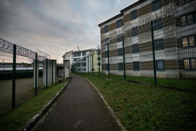 This photograph shows buildings behind barbwire at the Villenauxe-La-Grande prison in Villenauxe-La-Grande, northeastern France on November 3, 2025. (Photo by ARNAUD FINISTRE / AFP)