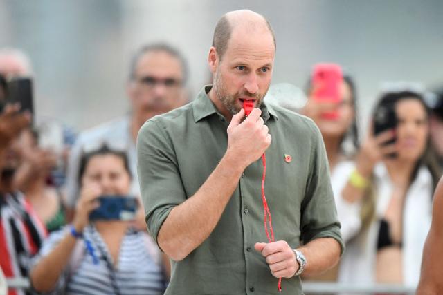 Britain's Prince William, Prince of Wales, blows a whistle during a meeting with first responder lifeguards at Copacabana Beach in Rio de Janeiro, Brazil on November 3, 2025. Prince William visits Brazil to host the Earthshot Prize awards and will later attend the UN COP30 climate summit on behalf of King Charles. (Photo by Daniel RAMALHO / AFP)