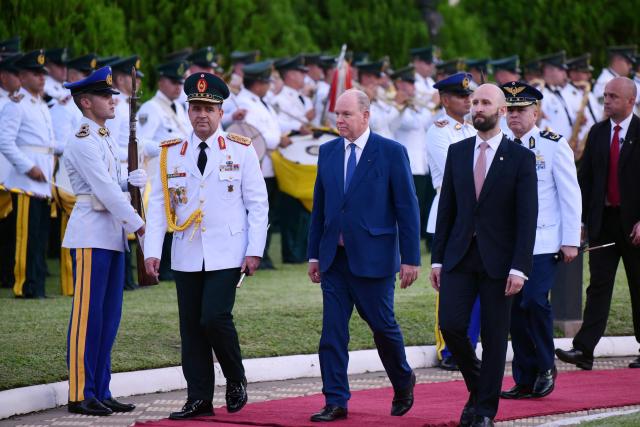 Prince Albert II of Monaco (C) reviews the guard of honor as he arrives at the Government Palace to an offical meeting with Paraguay's President Santiago Pena in Asuncion on November 3, 2025. (Photo by DANIEL DUARTE / AFP)