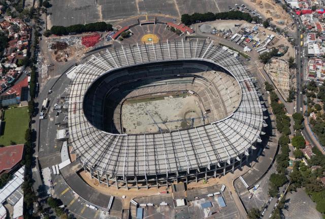 An aerial view of the Azteca Stadium in Mexico City taken on October 28, 2025. While millions celebrate Mexico hosting the FIFA World Cup for a third time, entire families of street vendors watch with concern as the football festivities threaten their long-standing source of income. (Photo by CARL DE SOUZA / AFP)