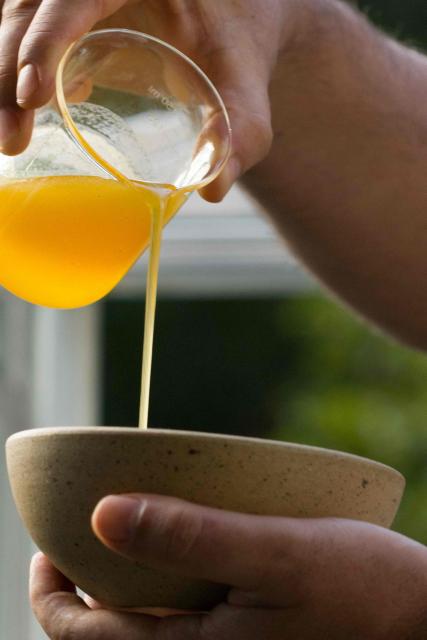 (FILES) Brazilian beekeeper Jeronimo Villas-Boas pours honey obtained from bees of the mandacaia species (Melipona quadrifasciata) in Itapecerica da Serra, some 50km from Sao Paulo, Brazil, on June 21, 2022. Chef Saulo Jennings, a leading figure in northern Brazilian cuisine, recently declined to cater the Earthshot Prize banquet in Rio de Janeiro -hosted by Britain's Prince William- after organizers requested a fully vegan menu, which he described as "a lack of respect" for Amazonian culinary traditions. He is, however, ready to impress heads of state at the COP30 meeting this week with dishes showcasing both plant and animal ingredients from the world's largest rainforest. (Photo by Fernando MARRON / AFP)