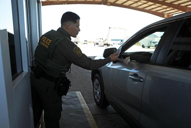 A US Border Patrol agent from the Big Bend Sector searches for drugs and irregular migrants at the Sierra Blanca checkpoint in Texas, United States, on November 3, 2025. (Photo by HERIKA MARTINEZ / AFP)