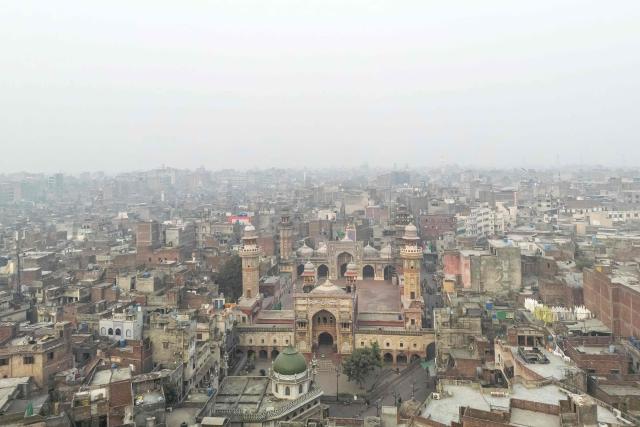 An aerial view shows the Wazir Khan Mosque (C) engulfed in dense smog in Lahore on November 4, 2025.  (Photo by Syed Murtaza Ali / AFP)
