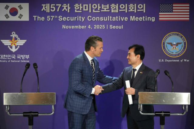 South Korean Defense Minister Ahn Gyu-Back (R) shakes hands with US Defense Secretary Pete Hegseth during a joint press conference following the 57th Security Consultative Meeting (SCM) at the Defense Ministry in Seoul on November 4, 2025. (Photo by Lee Jin-man / POOL / AFP)