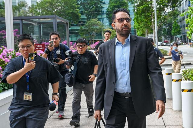 Pritam Singh, secretary general of the Singaporean opposition Workers' Party, leaves the Supreme Court during an appeals hearing against his conviction and sentence for lying to a Committee of Privileges (COP) parliamentary hearing in Singapore on November 4, 2025. (Photo by Roslan RAHMAN / AFP)