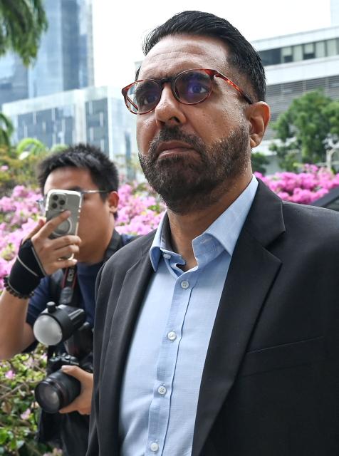 Pritam Singh, secretary general of the Singaporean opposition Workers' Party, leaves the Supreme Court during an appeals hearing against his conviction and sentence for lying to a Committee of Privileges (COP) parliamentary hearing in Singapore on November 4, 2025. (Photo by Roslan RAHMAN / AFP)