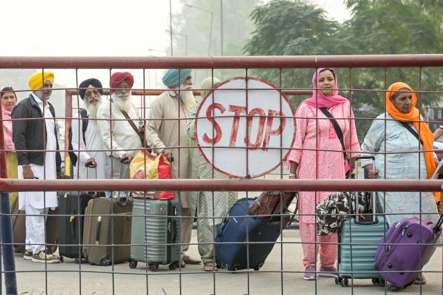 Indian Sikh pilgrims queue at the India-Pakistan Wagah border in Wagah on November 4, 2025, for their visit to Pakistan to pay their respects on the eve of celebrations marking the birth anniversary of Guru Nanak, founder of Sikhism. Indian Sikh pilgrims have been issued visas for neighbouring Pakistan, the first major allowance after travel between the arch-rival nations was frozen during conflict in May. (Photo by Narinder NANU / AFP)
