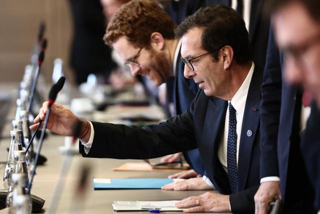 France's Labour Minister Jean-Pierre Farandou adjusts his microphone prior to the opening meeting of the Work and Pensions Conference at the Labour ministry in Paris, on November 4, 2025. (Photo by Thibaud MORITZ / AFP)