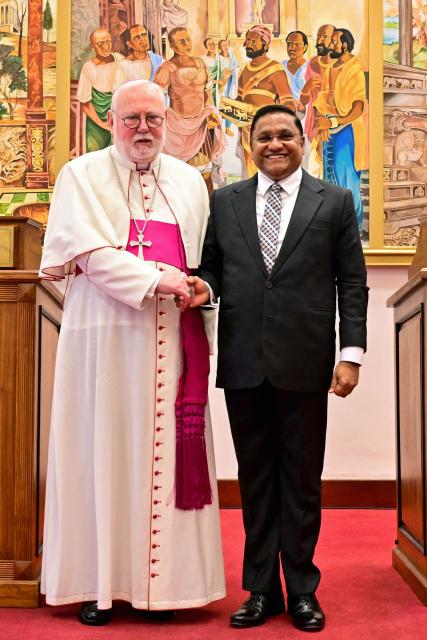Vijitha Herath (R), Sri Lanka's Foreign Minister shakes hands with Archbishop Paul Richard Gallagher, Secretary for Relations with States and International Organizations at the end of their joint press conference in Colombo on November 4, 2025. (Photo by Ishara S. KODIKARA / AFP)
