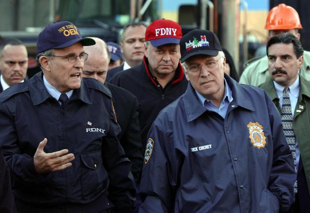 (FILES) US Vice President Dick Cheney (R) gets a tour from New York Mayor Rudolph Giuliani (L) at ground zero of the World Trade Center ruins 18 October 2001 in New York. It was the first time Cheney had visited the site since the 11 September attack. Cheney is wearing a New York Police Department jacket. Dick Cheney, who became one of the most powerful vice presidents in US history as George W. Bushs number two during 9/11 and catastrophic wars in Afghanistan and Iraq, died on November 3, 2025. He was 84. (Photo by STAN HONDA / POOL / AFP)