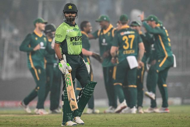 Pakistan's Babar Azam (front) reacts as he walks back to the pavilion after his dismissal during the first one-day international (ODI) cricket match between Pakistan and South Africa at the Iqbal Stadium in Faisalabad on November 4, 2025. (Photo by Aamir QURESHI / AFP)