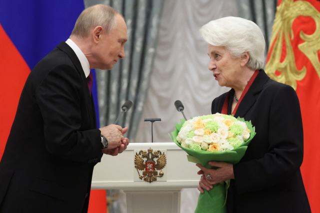 Russian President Vladimir Putin awards head of the Solzhenitsyn Foundation Natalia Solzhenitsyna with the Order For Merit to the Fatherland 3rd class during an awards ceremony marking the National Unity Day at the Kremlin in Moscow on November 4, 2025. (Photo by MAXIM SHIPENKOV / POOL / AFP)