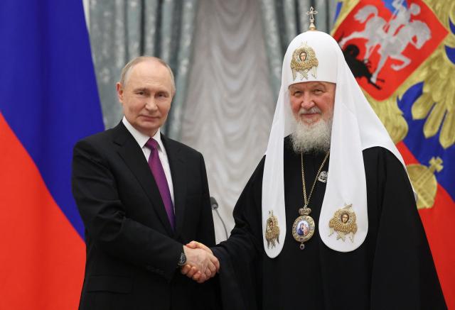 Russian President Vladimir Putin awards Patriarch Kirill of Moscow and All Russia with the Presidential Prize for Contributions to Strengthening Russia's National Unity during an awards ceremony marking the National Unity Day at the Kremlin in Moscow on November 4, 2025. (Photo by MAXIM SHIPENKOV / POOL / AFP)