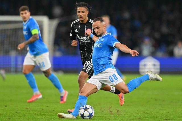 Napoli's Slovak midfielder #68 Stanislav Lobotka kicks the ball next to Frankfurt's French forward #19 Jean-Matteo Bahoya during the UEFA Champions League - league phase day 4 football match between Napoli and Eintracht Frankfurt at the Diego Armando Maradona stadium in Naples on November 4, 2025. (Photo by Andreas SOLARO / AFP)