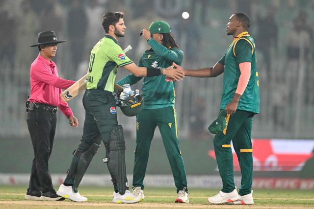 Pakistan's captain Shaheen Shah Afridi (2L) shakes hands with South Africa's Lungi Ngidi (R) at the end of the first one-day international (ODI) cricket match between Pakistan and South Africa at the Iqbal Stadium in Faisalabad on November 4, 2025. (Photo by Aamir QURESHI / AFP)