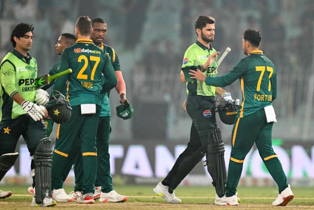 Pakistan's captain Shaheen Shah Afridi (2R) shakes hands with South Africa's Bjorn Fortuin (R) at the end of the first one-day international (ODI) cricket match between Pakistan and South Africa at the Iqbal Stadium in Faisalabad on November 4, 2025. (Photo by Aamir QURESHI / AFP)