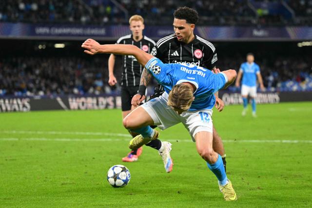 Napoli's Danish forward #19 Rasmus Hojlund fights for the ball with Frankfurt's German-Nigerian defender #34 Nnamdi Collins during the UEFA Champions League - league phase day 4 football match between Napoli and Eintracht Frankfurt at the Diego Armando Maradona stadium in Naples on November 4, 2025. (Photo by Andreas SOLARO / AFP)