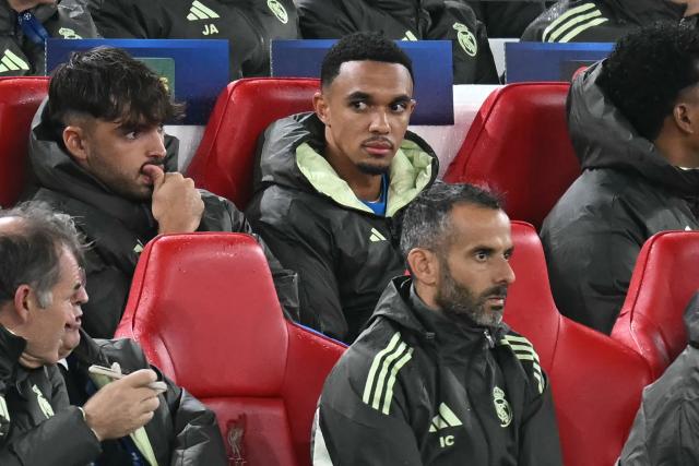 Real Madrid's English defender #12 Trent Alexander-Arnold (C) looks on from his seat on the bench during the UEFA Champions League, league phase football match between Liverpool and Real Madrid at Anfield in Liverpool, north west England on November 4, 2025. (Photo by Paul ELLIS / AFP)
