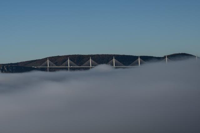 The mist rises below the Viaduct of Millau on November 4, 2025 in Compeyre, central France. (Photo by Martin BUREAU / AFP)