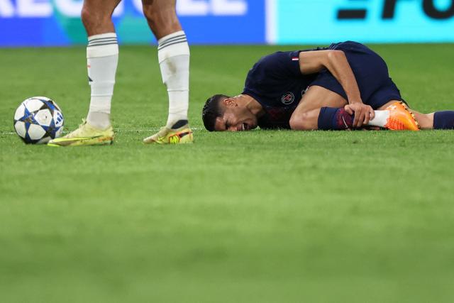 Paris Saint-Germain's Moroccan defender #02 Achraf Hakimi reacts after picking up an injury during the UEFA Champions League, league phase day 4, football match between Paris Saint-Germain (PSG) and FC Bayern Munich at the Parc des Princes in Paris, on November 4, 2025. (Photo by Anne-Christine POUJOULAT / AFP)