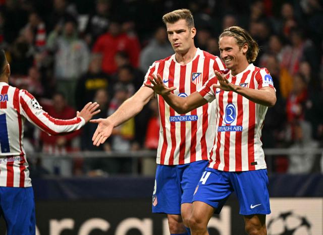 Atletico Madrid's Spanish midfielder #14 Marcos Llorente celebrates with teammates scoring his team's third goal during the UEFA Champions League league phase day 4 football match between Club Atletico de Madrid and Union St-Gilloise at the Metropolitano Stadium in Madrid on November 4, 2025. (Photo by JAVIER SORIANO / AFP)