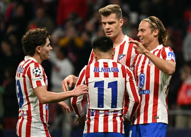 Atletico Madrid's Spanish midfielder #14 Marcos Llorente celebrates with teammates scoring his team's third goal during the UEFA Champions League league phase day 4 football match between Club Atletico de Madrid and Union St-Gilloise at the Metropolitano Stadium in Madrid on November 4, 2025. (Photo by JAVIER SORIANO / AFP)