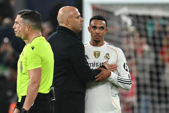 Liverpool's Dutch manager Arne Slot (C) speaks with Real Madrid's English defender #12 Trent Alexander-Arnold (R) on the pitch after the UEFA Champions League, league phase football match between Liverpool and Real Madrid at Anfield in Liverpool, north west England on November 4, 2025. Liverpool won the game 1-0. (Photo by Paul ELLIS / AFP)