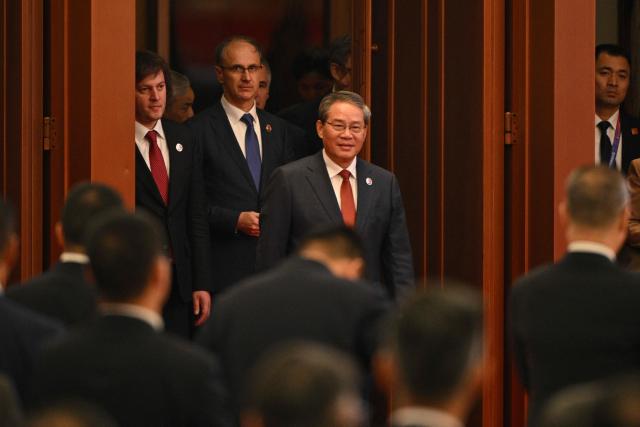 China's Premier Li Qiang arrives to the opening ceremony of the 8th China International Import Expo (CIIE) and the Hongqiao International Economic Forum in Shanghai on November 5, 2025. (Photo by Hector RETAMAL / AFP)