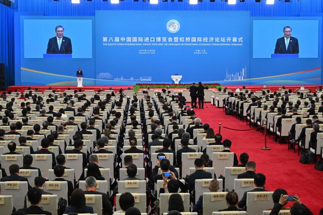 Chinese Commerce Minister Wang Wentao speaks during the opening ceremony of the 8th China International Import Expo (CIIE) and the Hongqiao International Economic Forum in Shanghai on November 5, 2025. (Photo by Hector RETAMAL / AFP)